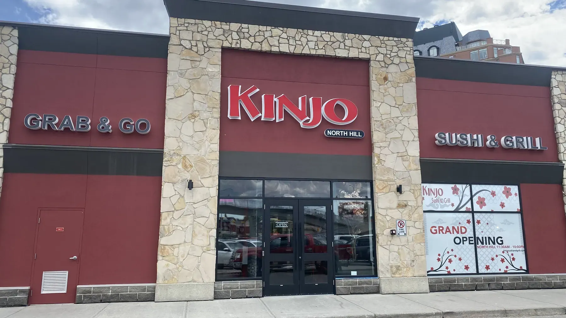 Commercial restaurant storefront with red stucco and stone pilasters